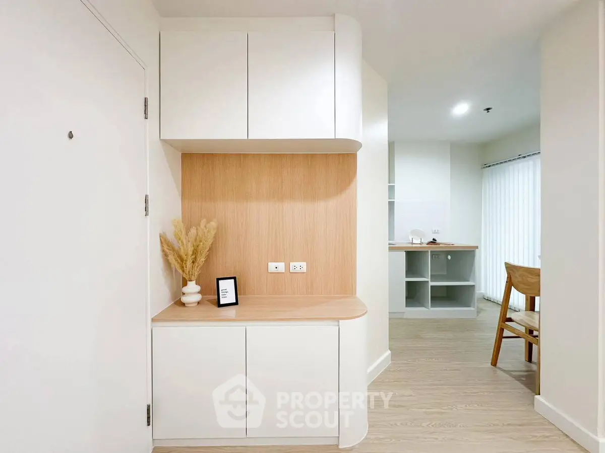 Modern minimalist interior with sleek cabinetry and natural wood accents in a bright living space.