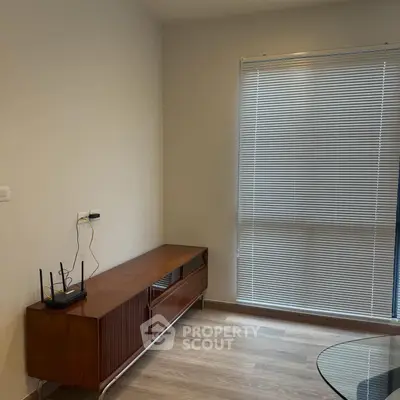 Modern minimalist living room corner with wooden cabinet and blinds