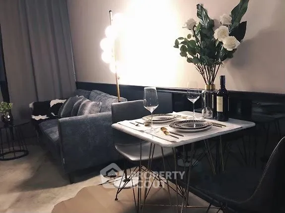 Stylish modern living room with cozy sofa and elegant dining setup, perfect for urban living.
