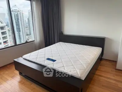 Spacious bedroom with city view and modern wooden flooring