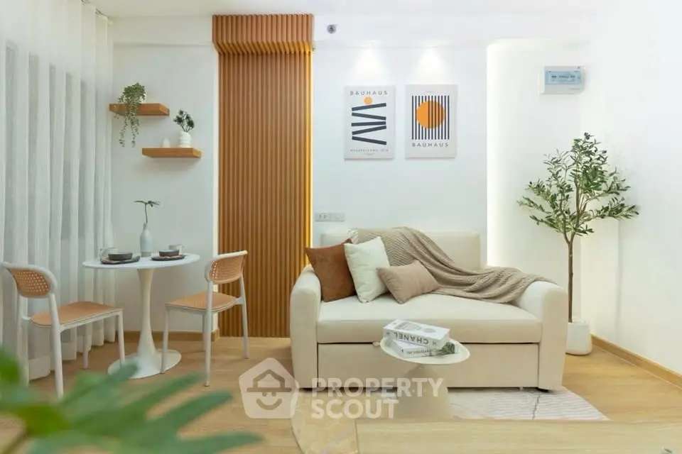 Stylish modern living room with cozy sofa, elegant decor, and natural light, perfect for relaxation.