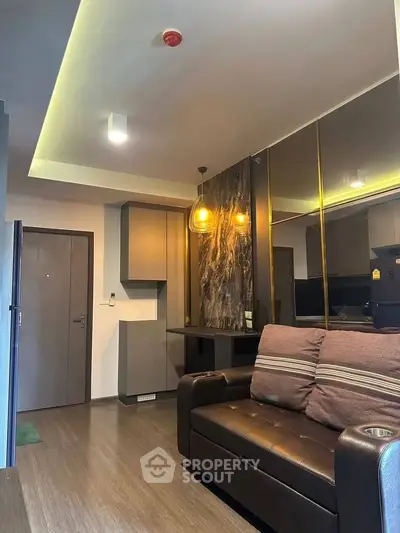 Modern living room with stylish lighting and sleek furniture design.