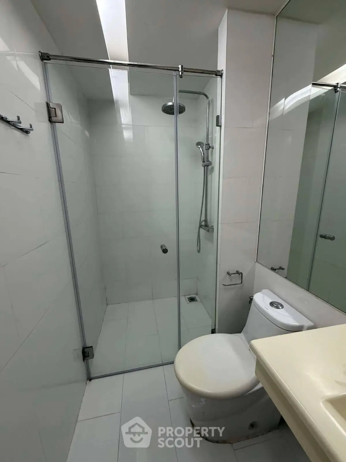 Modern bathroom with glass shower enclosure and sleek fixtures