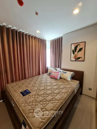 Cozy bedroom with elegant decor and large windows for natural light.