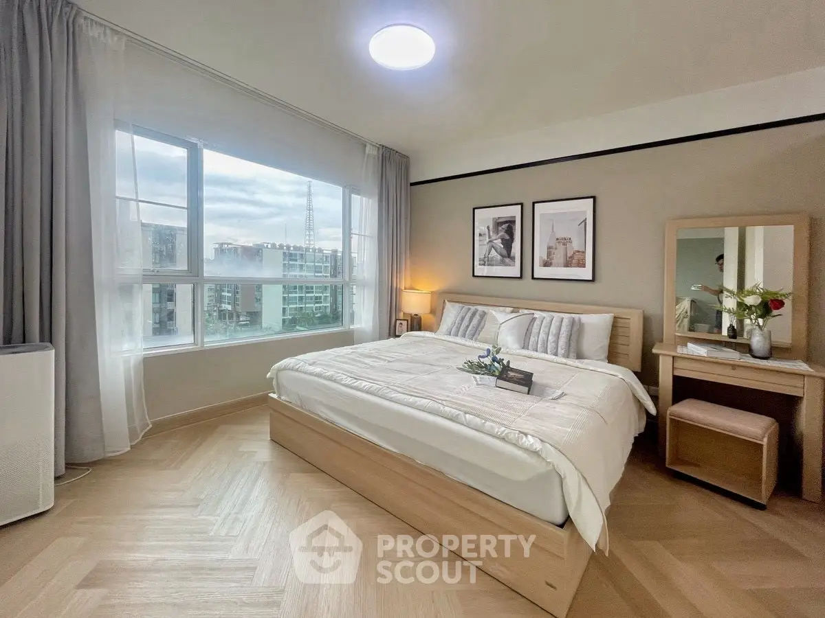 Bright and cozy bedroom with large window and modern decor