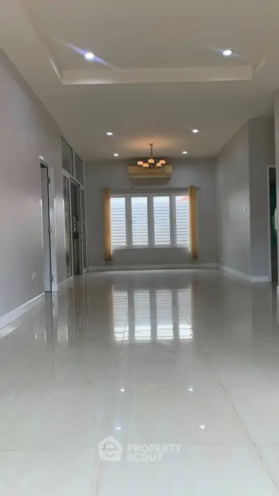Spacious modern living room with polished floors and elegant lighting