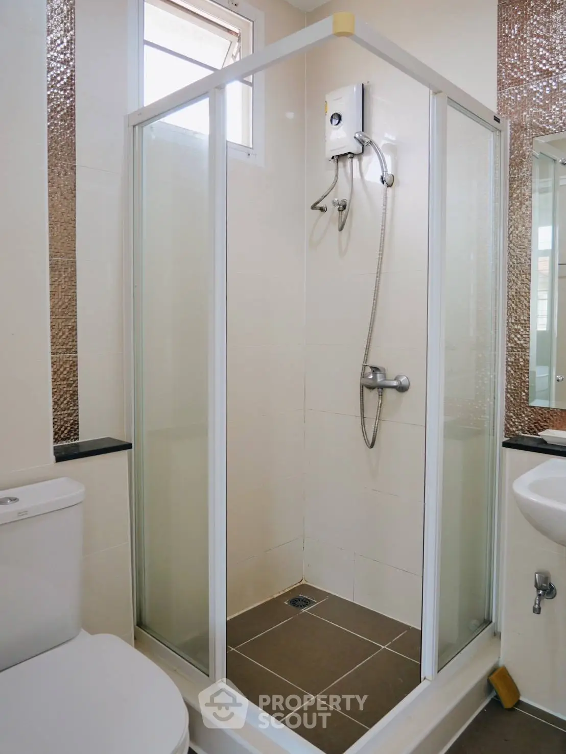 Modern bathroom with glass shower enclosure and sleek fixtures