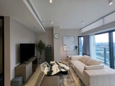 Luxurious living room with modern decor and stunning city view from balcony.