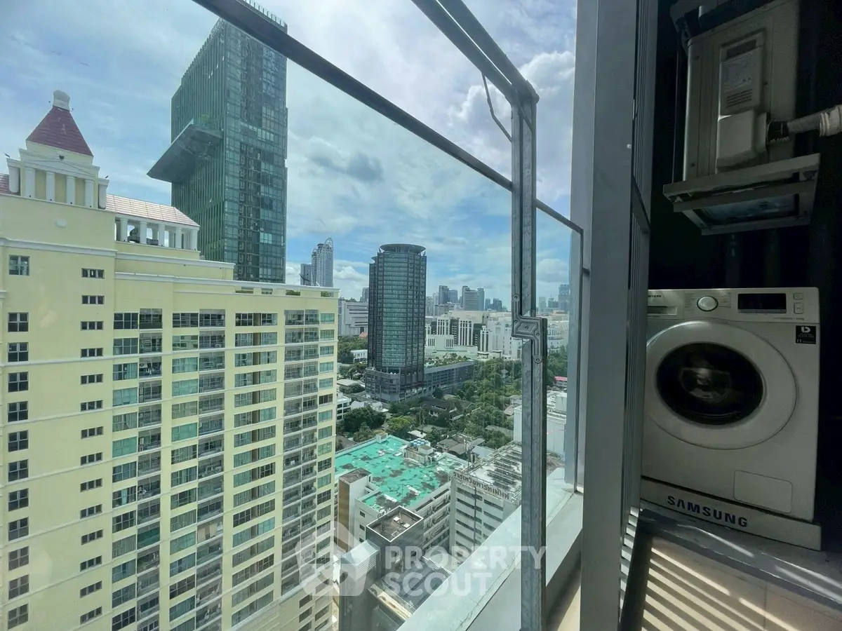 Stunning city view from high-rise balcony with modern washing machine.