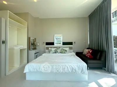 Spacious bedroom with modern decor and natural light