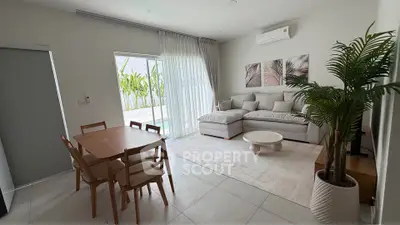 Modern living room with elegant decor, large windows, and pool view, perfect for relaxation and entertaining.