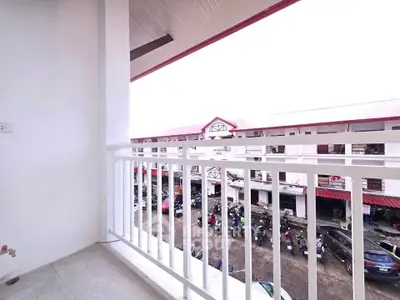 Spacious balcony with a view of a bustling marketplace, perfect for enjoying vibrant city life.