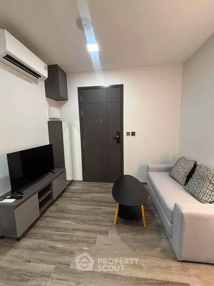 Modern living room with sleek furniture and air conditioning in a stylish apartment.