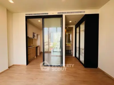 Modern apartment interior with sliding glass doors and wooden flooring