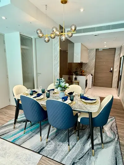 Luxurious dining area with elegant decor and modern kitchen in open layout