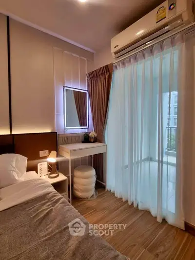 Cozy bedroom with modern decor and balcony access, featuring soft lighting and elegant curtains.
