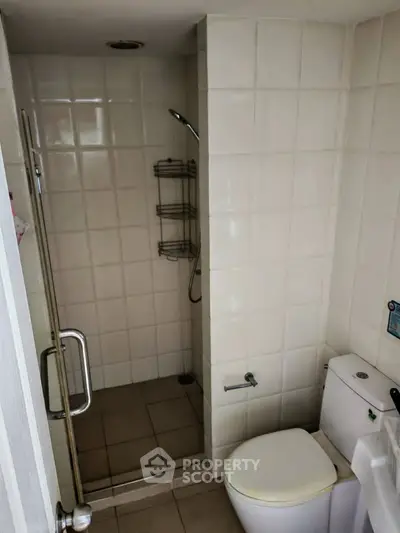 Compact bathroom with shower and toilet in modern apartment