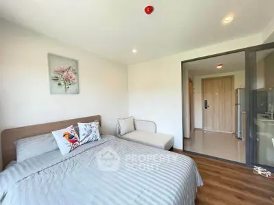 Modern bedroom with cozy decor and natural light, featuring a comfortable bed and stylish furniture.