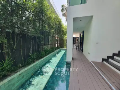 Modern property with sleek pool and lush greenery, perfect for luxury living.