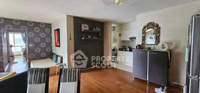 Spacious open-plan living room with stylish decor and modern kitchen area