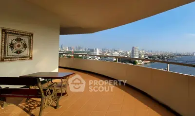 Spacious balcony with stunning city and river views in luxury apartment.