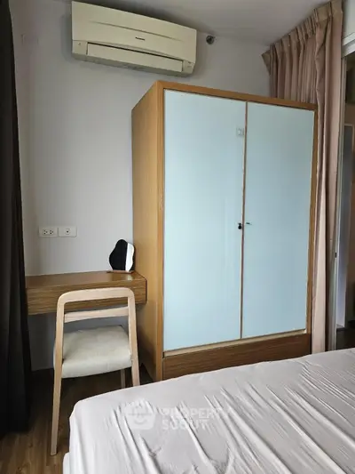Modern bedroom with air conditioning and stylish furniture