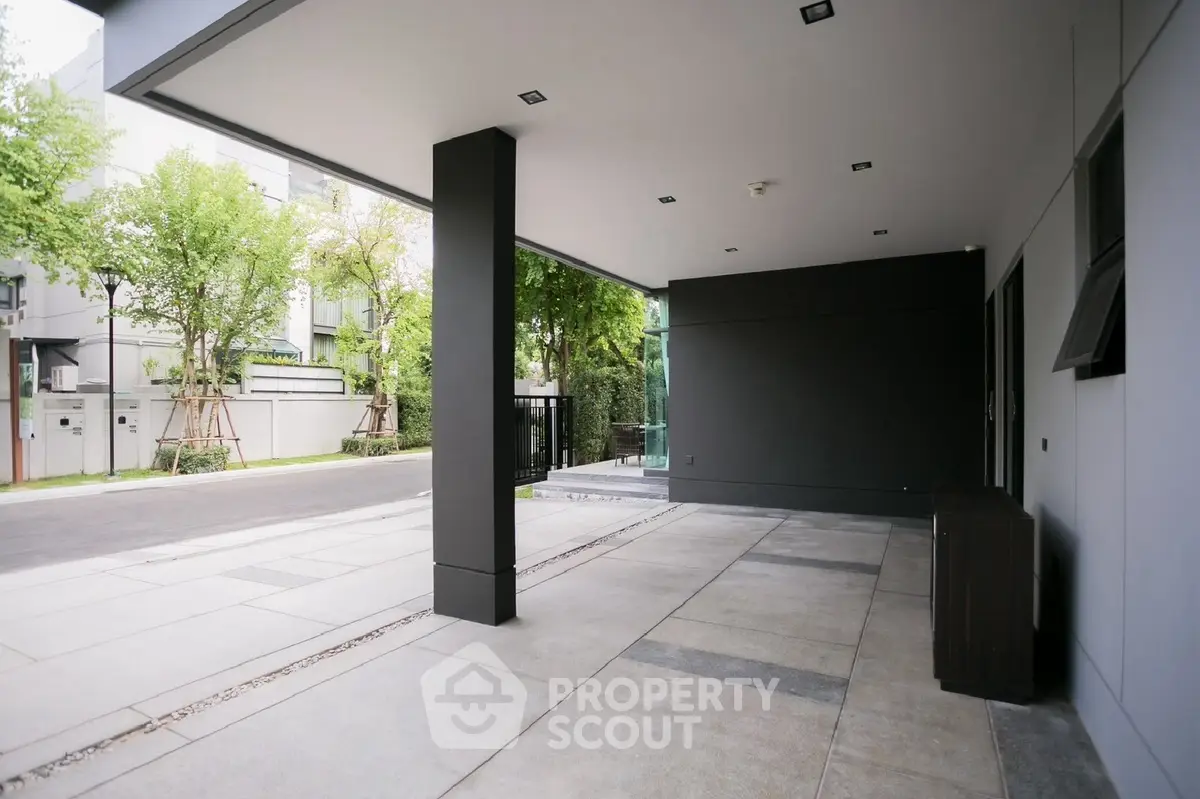 Spacious modern outdoor patio with sleek design and lush greenery view.