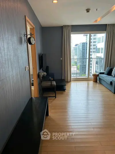 Spacious modern living room with balcony and city view