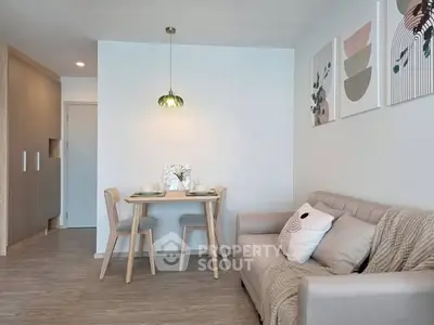 Modern living room with cozy sofa and dining area in stylish apartment
