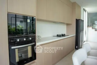 Modern kitchen with sleek cabinetry and built-in appliances in a stylish home.