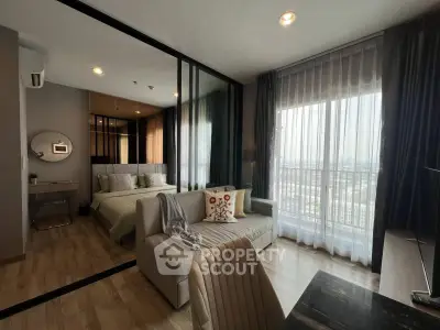 Modern studio apartment with stylish decor and city view, featuring a cozy living area and elegant bedroom.