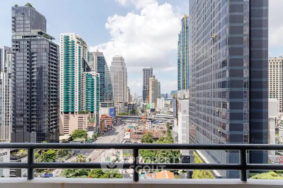 Stunning cityscape view from a high-rise balcony in a bustling urban area.