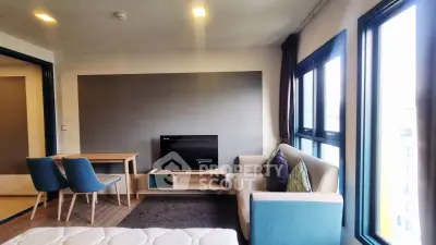 Modern living room with stylish furniture and large windows offering ample natural light.