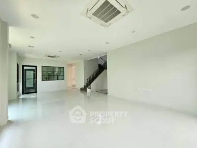 Spacious modern living room with sleek design and central air conditioning