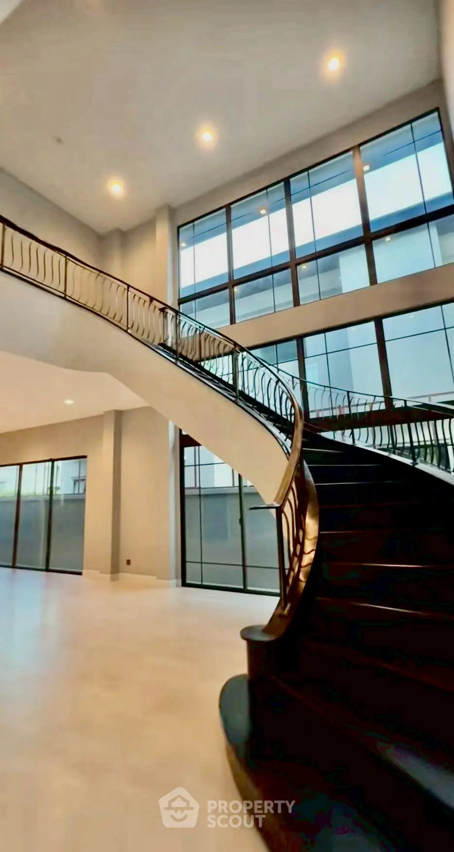 Luxurious modern staircase with elegant railing in spacious open-concept home interior