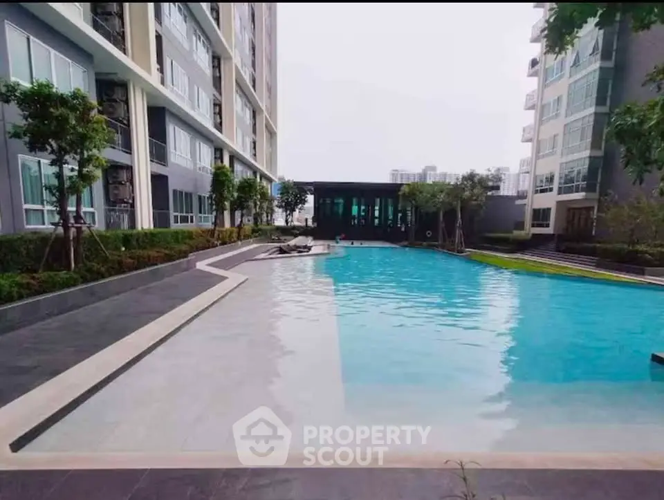 Luxurious residential building with a stunning outdoor pool and modern architecture.