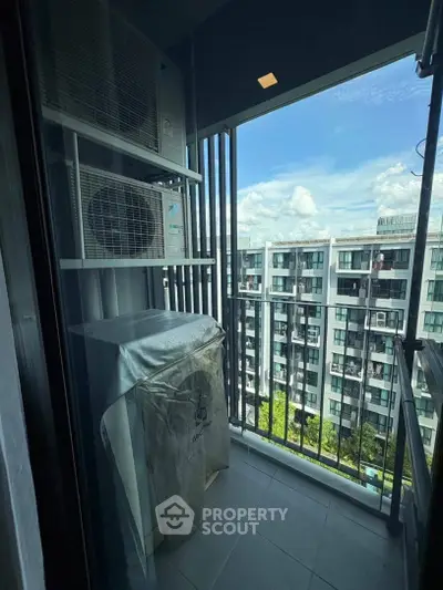 Modern apartment balcony with air conditioning unit and city view