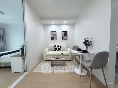 Modern living room with cozy seating and dining area in a stylish apartment.