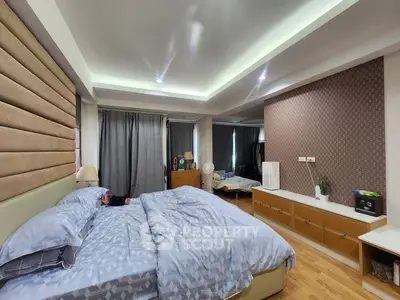 Spacious bedroom with modern decor and ambient lighting