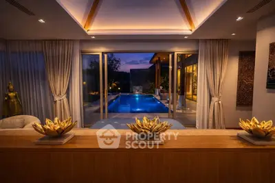 Luxurious living room with pool view and elegant decor at dusk