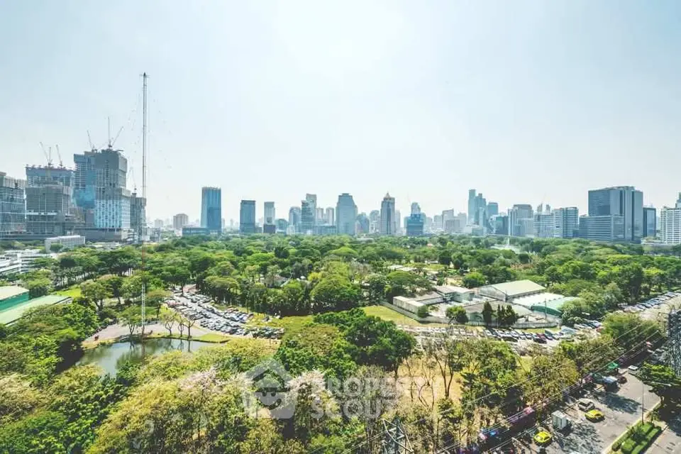Stunning cityscape view with lush green park and modern skyline, perfect for urban living enthusiasts.