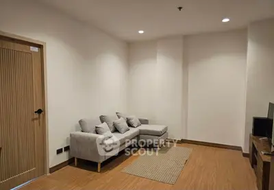 Cozy living room with modern gray sofa and wooden flooring