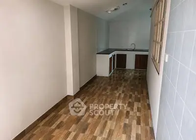 Charming narrow kitchen with wooden cabinets and tiled flooring, perfect for cozy cooking experiences.