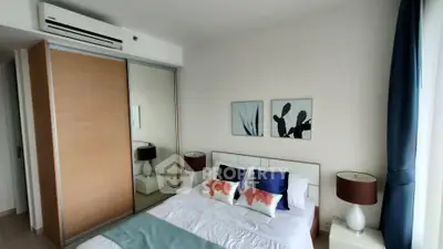 Modern bedroom with stylish decor and mirrored closet doors