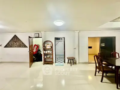 Spacious interior with elegant dining area and decorative wall art, perfect for family gatherings.