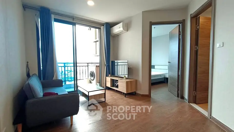 Modern apartment living room with balcony and wooden flooring