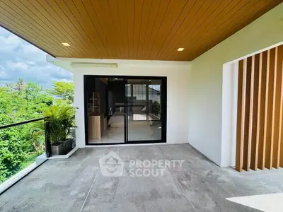 Spacious balcony with modern design and lush greenery view