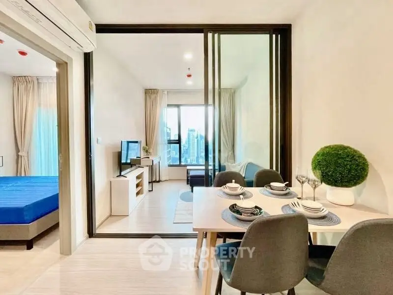 Modern open-plan living and dining area with stylish decor and city view.