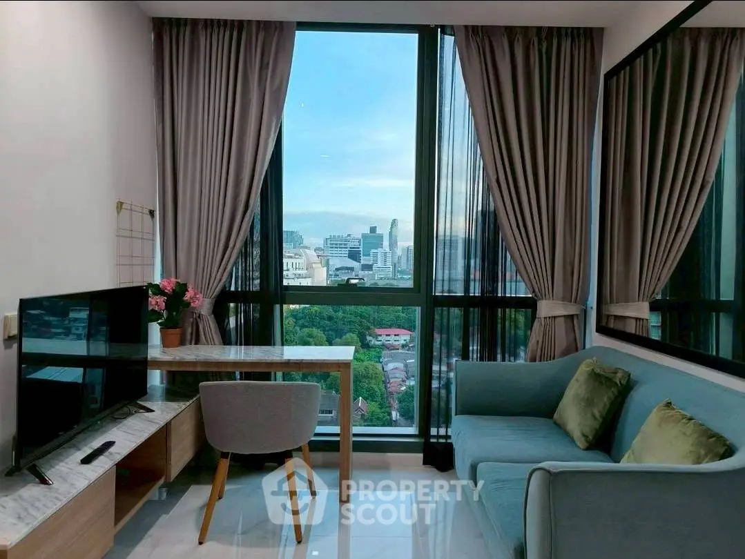 Modern living room with stunning city view, elegant decor, and floor-to-ceiling windows.