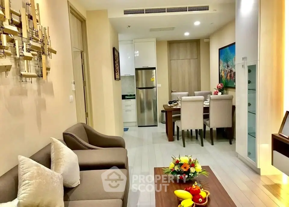 Modern living room with stylish decor and open dining area in a cozy apartment.